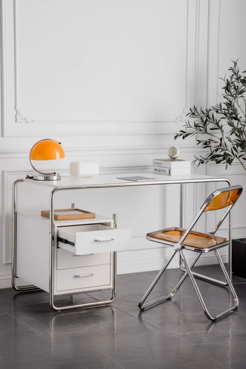 Modern office desk with a chair and decorative items in a minimalistic room.